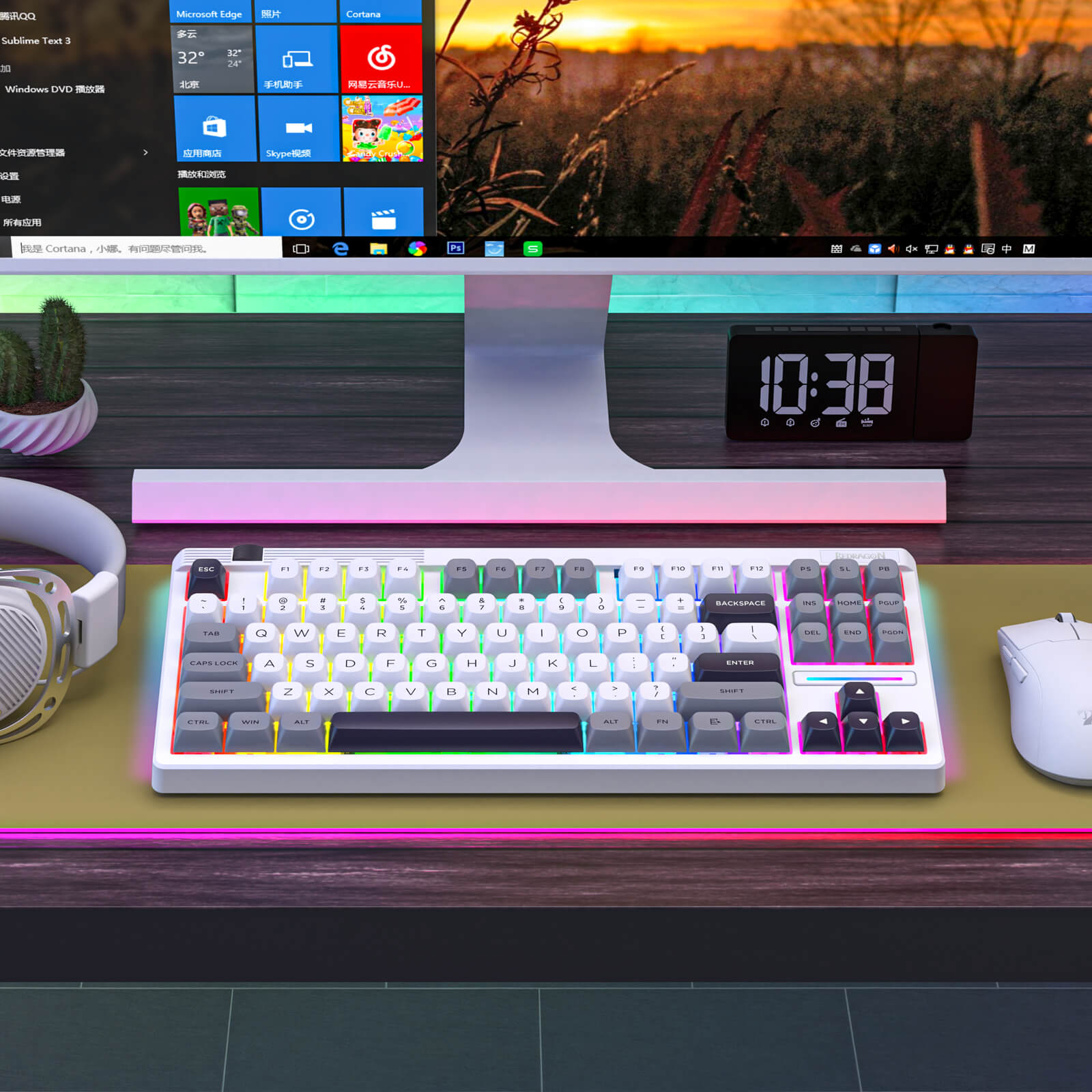 Keyboard on a desk with a computer monitor, clock, and headphones in the background.